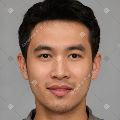 Joyful asian young-adult male with short  brown hair and brown eyes