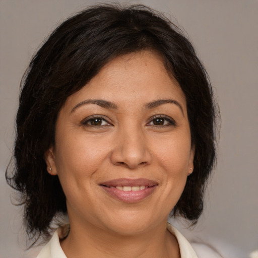 Joyful white adult female with medium  brown hair and brown eyes