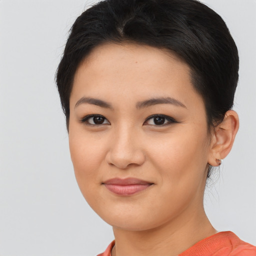 Joyful asian young-adult female with short  brown hair and brown eyes