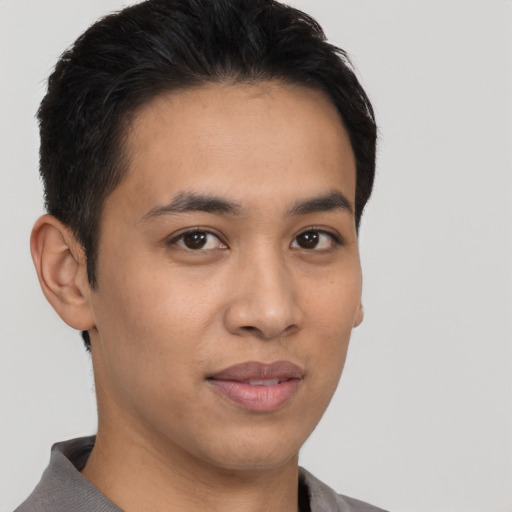 Joyful latino young-adult male with short  brown hair and brown eyes