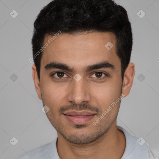 Joyful white young-adult male with short  black hair and brown eyes