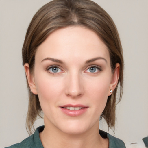 Joyful white young-adult female with medium  brown hair and blue eyes