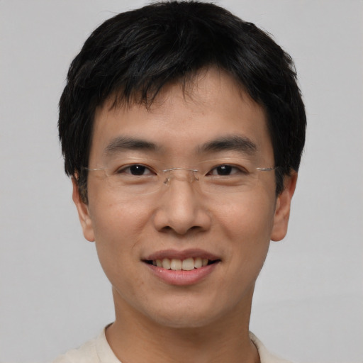 Joyful asian young-adult male with short  black hair and brown eyes