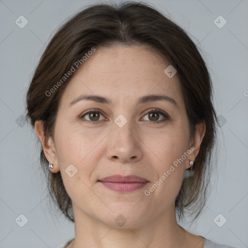 Joyful white adult female with medium  brown hair and grey eyes