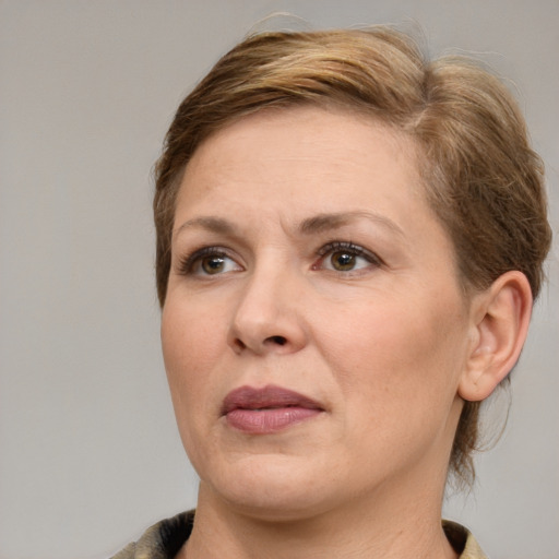 Joyful white adult female with medium  brown hair and brown eyes