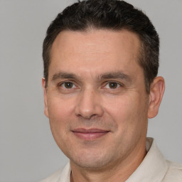 Joyful white adult male with short  brown hair and brown eyes