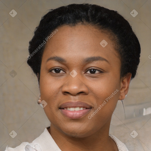 Joyful black young-adult female with short  black hair and brown eyes