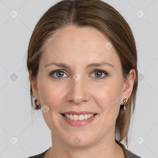 Joyful white adult female with medium  brown hair and grey eyes