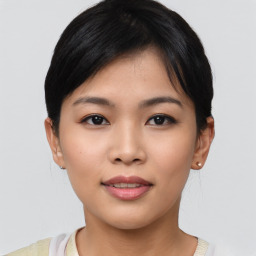 Joyful asian young-adult female with short  black hair and brown eyes