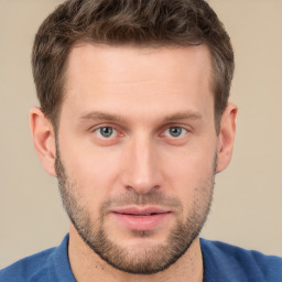 Joyful white young-adult male with short  brown hair and grey eyes