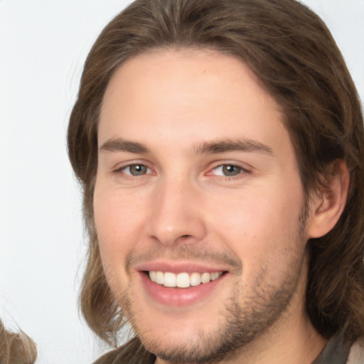 Joyful white young-adult male with medium  brown hair and brown eyes