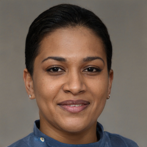 Joyful black young-adult female with short  brown hair and brown eyes