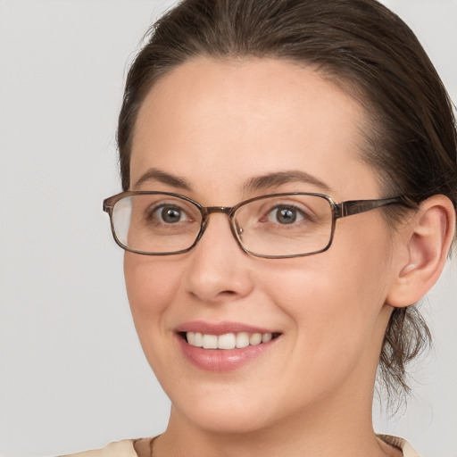 Joyful white young-adult female with medium  brown hair and brown eyes