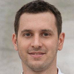 Joyful white young-adult male with short  brown hair and brown eyes