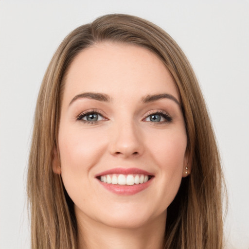 Joyful white young-adult female with long  brown hair and green eyes