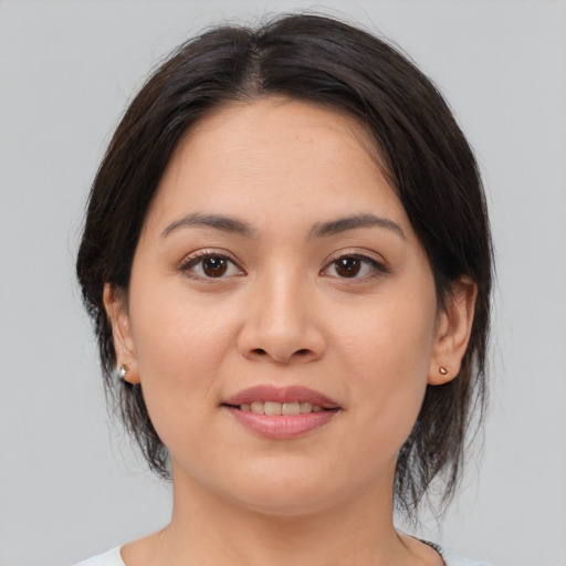 Joyful asian young-adult female with medium  brown hair and brown eyes