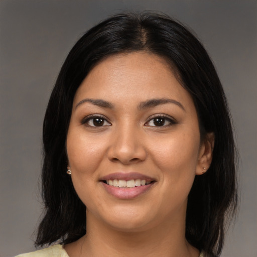Joyful latino young-adult female with medium  black hair and brown eyes