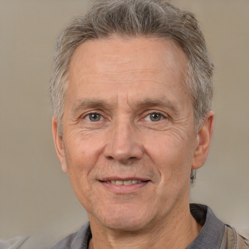 Joyful white middle-aged male with short  gray hair and brown eyes