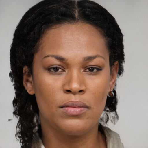 Neutral black young-adult female with long  brown hair and brown eyes