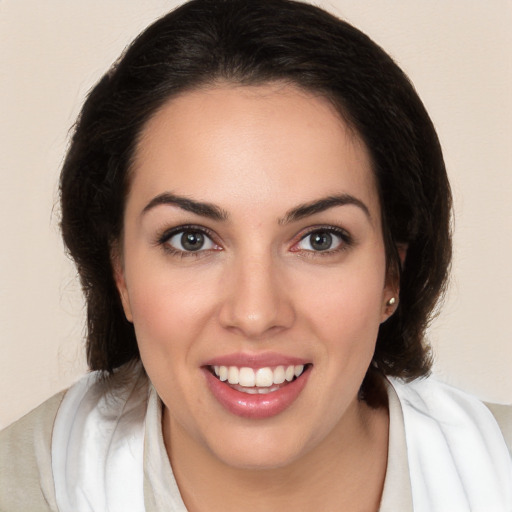 Joyful white young-adult female with medium  brown hair and brown eyes