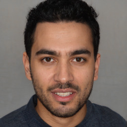 Joyful white young-adult male with short  black hair and brown eyes