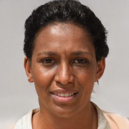 Joyful black adult female with short  brown hair and brown eyes