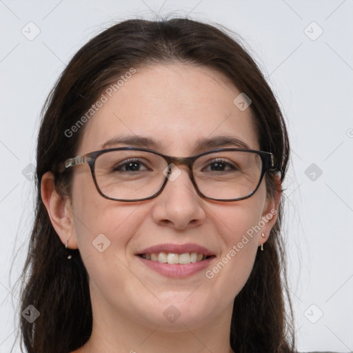 Joyful white adult female with long  brown hair and grey eyes