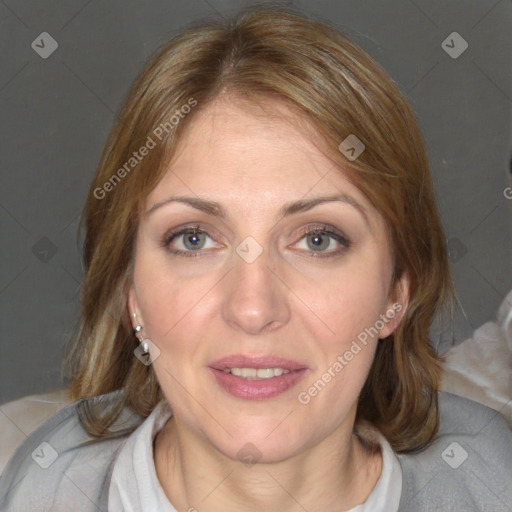 Joyful white adult female with medium  brown hair and blue eyes