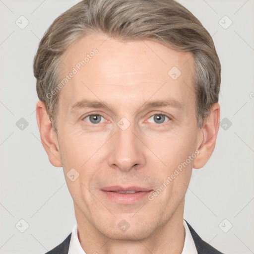 Joyful white adult male with short  brown hair and grey eyes