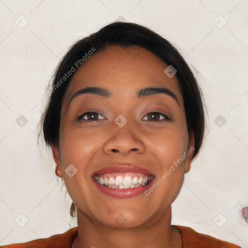 Joyful latino young-adult female with medium  brown hair and brown eyes