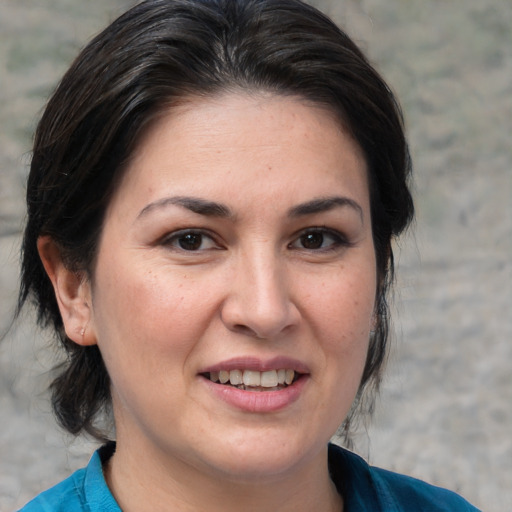 Joyful white adult female with medium  brown hair and brown eyes