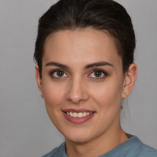 Joyful white young-adult female with short  brown hair and brown eyes