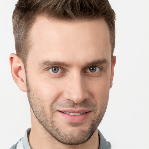 Joyful white young-adult male with short  brown hair and grey eyes