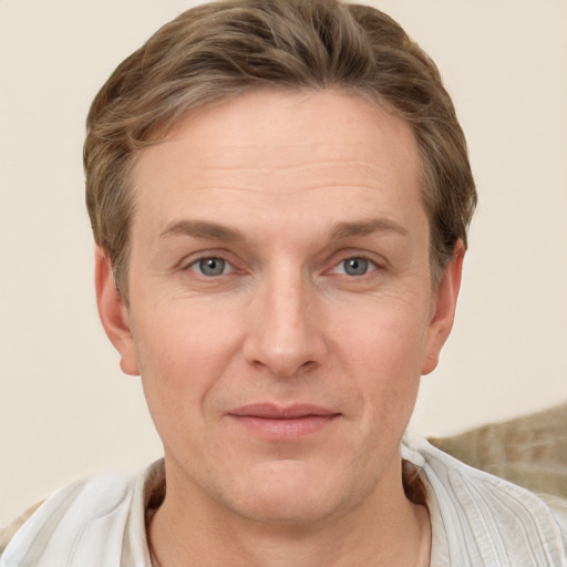 Joyful white adult male with short  brown hair and grey eyes