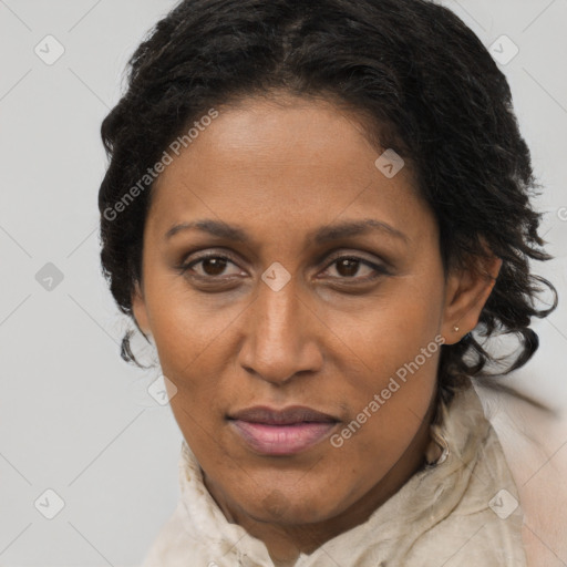 Joyful black adult female with medium  brown hair and brown eyes