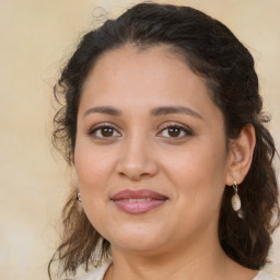 Joyful latino young-adult female with medium  brown hair and brown eyes