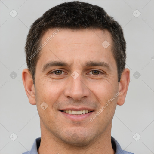 Joyful white adult male with short  brown hair and brown eyes