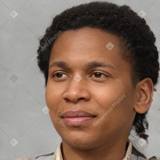 Joyful black young-adult male with short  brown hair and brown eyes