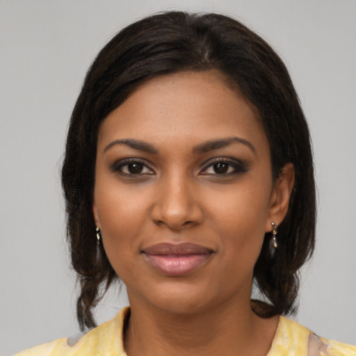 Joyful black young-adult female with medium  brown hair and brown eyes