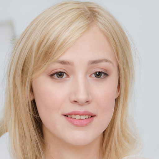 Joyful white young-adult female with long  blond hair and blue eyes