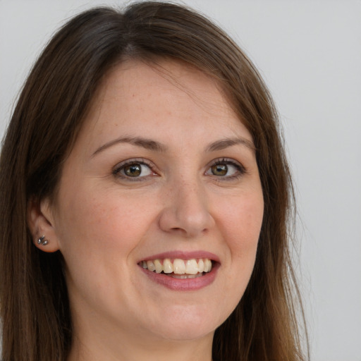 Joyful white young-adult female with long  brown hair and grey eyes