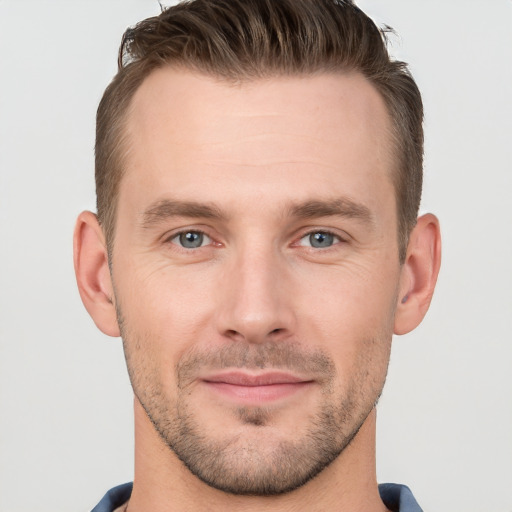 Joyful white young-adult male with short  brown hair and grey eyes