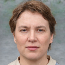 Joyful white adult female with medium  brown hair and grey eyes