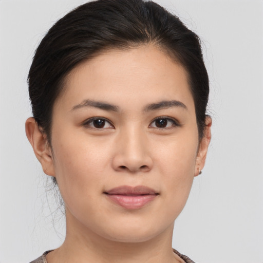 Joyful asian young-adult female with medium  brown hair and brown eyes