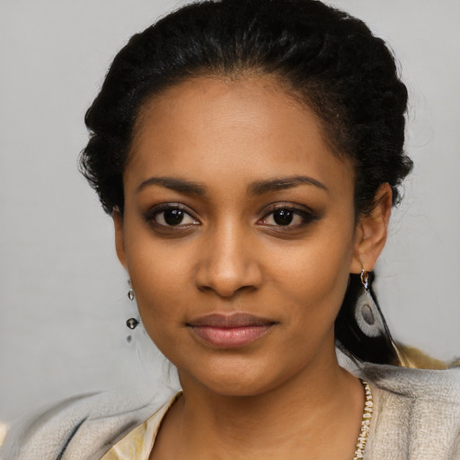 Joyful latino young-adult female with short  black hair and brown eyes