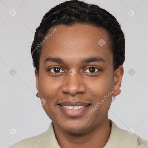 Joyful black young-adult male with short  black hair and brown eyes