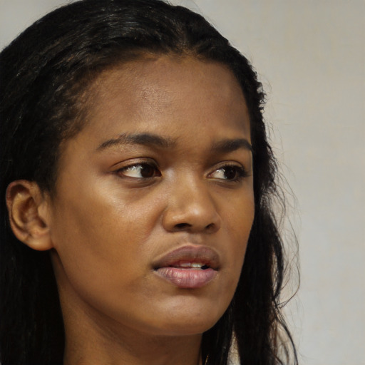 Neutral black young-adult female with long  brown hair and brown eyes