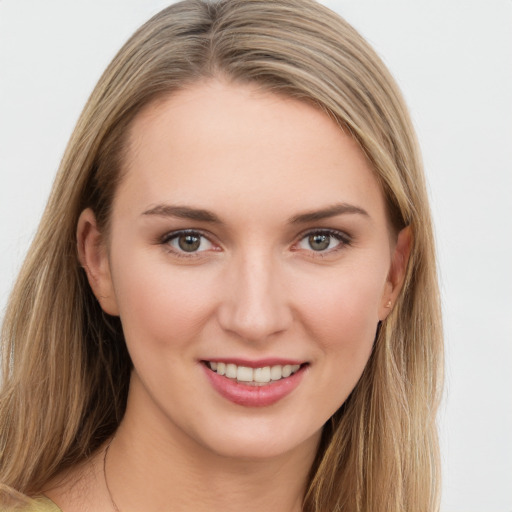 Joyful white young-adult female with long  brown hair and grey eyes