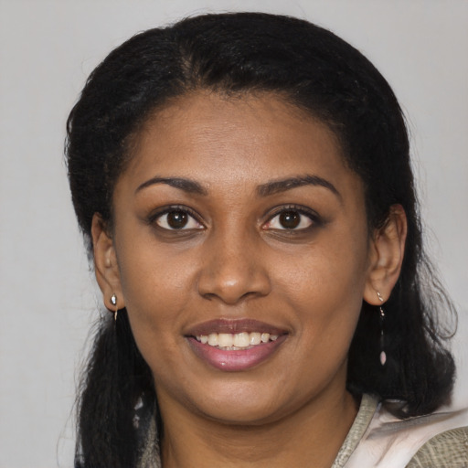 Joyful latino young-adult female with medium  black hair and brown eyes