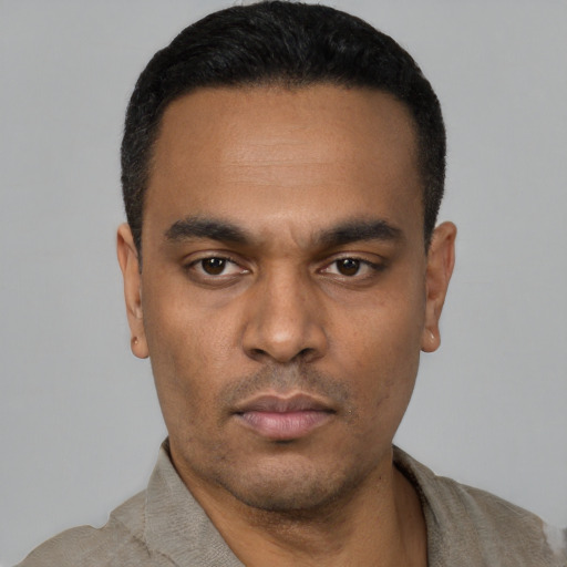 Neutral latino young-adult male with short  black hair and brown eyes